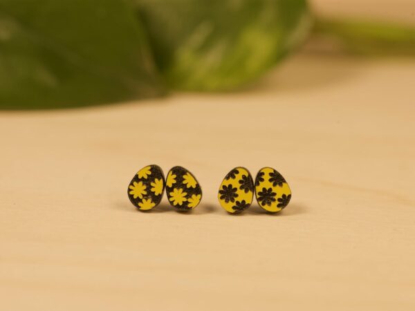 Acrylic black and yellow daisy design Easter egg stud earrings.