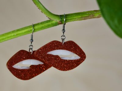 Acrylic large lip shaped dangle earrings, in various colors.